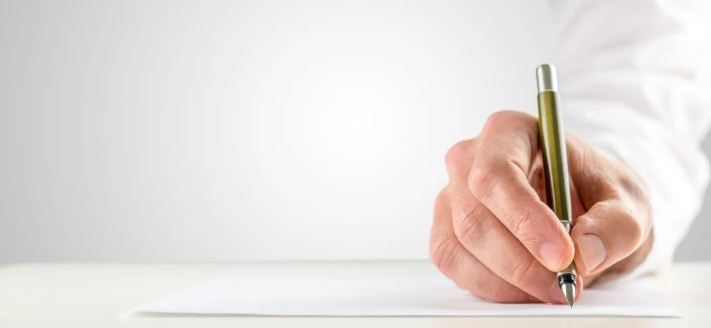 A hand writing with a fountain pen
